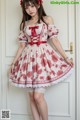 a woman in a red and white dress posing for a picture